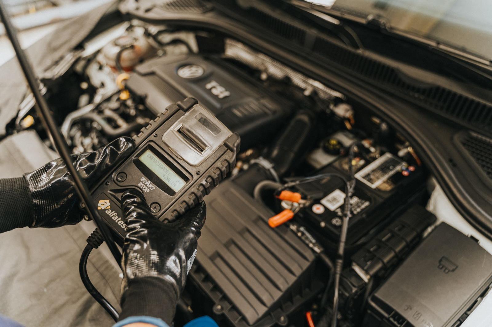 Technician checking under the bonnet during a car service